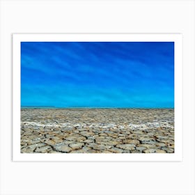 Cracked Earth Texture in Camargue. The image showcases a close-up view of cracked earth, revealing a network of intricate fissures and crevices. The dominant color is a muted gray, with subtle variations in shade and texture. The cracks are deep and pronounced, creating a sense of dryness and aridity. The overall mood is one of desolation and harshness, highlighting the effects of drought or lack of moisture. 2 Art Print