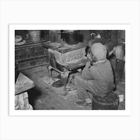 Boy Sitting By The Stove On A Cold Day In The Strawberry Picking Season, Near Independence, Louisiana By Russell Lee Art Print