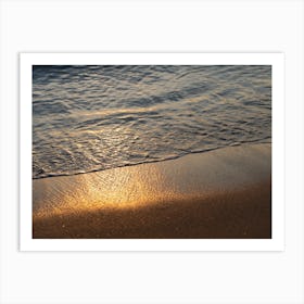 Sea water meets golden sand at sunrise Art Print