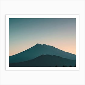 Photo Of A Mountain Range Silhouetted Against A Blue And Orange Sky Art Print