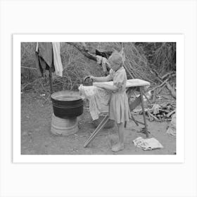 Child Of White Migrant Worker Ironing In Camp Near Harlingen, Texas By Russell Lee Art Print