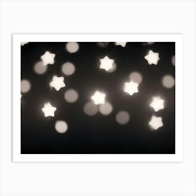 A Photograph Of A String Of White Star Shaped Lights On A Dark Background Art Print