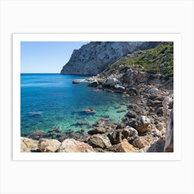 Turquoise sea water and rocky beach Art Print
