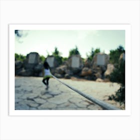 Young Girl Trying To Go Into The Distance As She Tied By A Rope Art Print