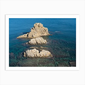 Rocks and clear blue sea water Art Print