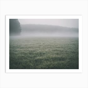 A Large Open Field With Grass On A Misty Day Art Print