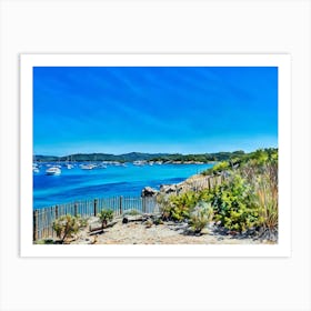 Serene Seascape Escape. The image depicts a tranquil coastal scene featuring a small, lush island surrounded by clear blue waters. Several boats are anchored nearby, and a person is seen riding a jet ski, leaving a trail of white foam behind. The sky is clear, enhancing the vibrant blue hues of the sea and sky, creating a picturesque and serene atmosphere. 3 Art Print