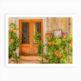 Traditional flower pots decorate the walls of the narrow streets and residential buildings, bringing color and beauty to the village's charming architecture. These potted plants are not only a nod to the island's Mediterranean culture, but also a symbol of the village's rich history and tradition. Art Print