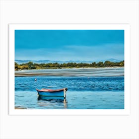 Serene Blue Boat. This image shows a small, colorful boat floating calmly on a serene body of water, with a backdrop of distant mountains and a blue sky. The setting is tranquil, with gentle ripples on the water and a shoreline lined with trees. Art Print