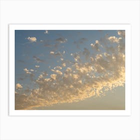 Soft clouds and warm sunlight at sunset Art Print
