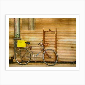 Bicycle Leaning Against Rusty Shutters Art Print