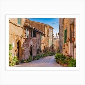 Majorca Spain, plant street in the old village Valldemossa. Explore the historic village of Valldemossa in Majorca, Spain and wander through its charming streets adorned with lush greenery. Admire the rustic architecture and ancient walls, while soaking up the Mediterranean culture and sunny weather. Art Print