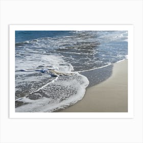 Blue sea water meets sand on the beach Art Print