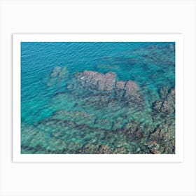 Aerial view of rocks and blue sea water Art Print
