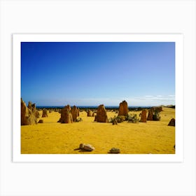 Orange Sand With Dark Rock Formations And Deep Blue Sky Art Print