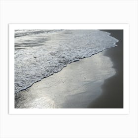 Silver-grey sea water on the sandy beach Art Print