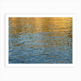 Golden reflections in blue sea water Art Print