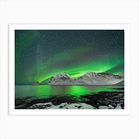 Aurora over winter mountain range Art Print