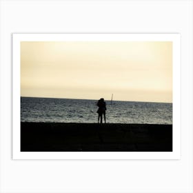 Silhouette Of An Embracing Couple Looking At The Sea Art Print