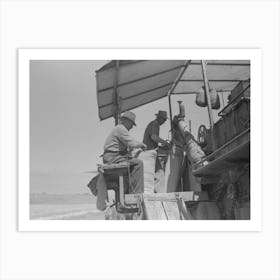 Walla Walla County, Washington, Men On The Combine In A Wheat Field, The Man In The Foreground Is Sewing Up Th Art Print