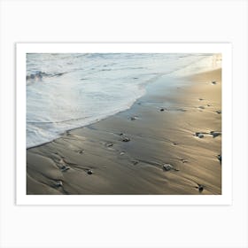 Sea water flows over shiny sand Art Print