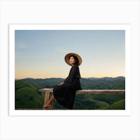 Evening View Of An Asian Woman Perched Solo On A Wooden Terrace Decked In A Summer Hat Her Black At Art Print