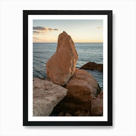 Rocks and the sea at sunset Art Print