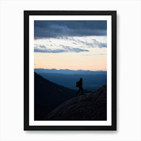 Silhouette Of A Lone Hiker Against A Vast Panorama Including Mountain Peaks Cutting Into The Horizo Art Print