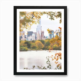 New York, USA I Central Park lake in the nature with autumn aesthetic and pastel orange tones in the wild tree leaves with the New York skyline, its skyscraper buildings and grandiose architecture photography Art Print