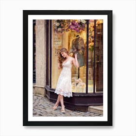 Young Woman Leaning Casually Against A Vintage Style Shop Window Lace Dress Billowing Slightly In T Art Print