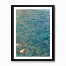 Clear sea water and reflections in a rocky bay Art Print