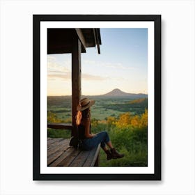 Woman Exuding A Sense Of Freedom While Sitting On A Wooden Porch Overlooking A Vast Hill And Sky Th Art Print