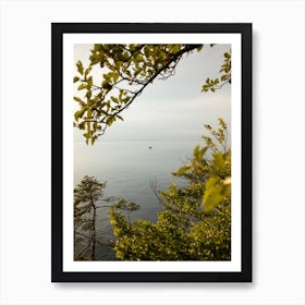 Boat In The Water through the trees Art Print