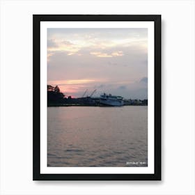 Sunset view of a river while a commercial boat passing through it Art Print