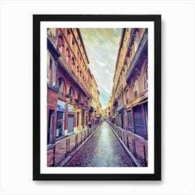 Toulouse Carmes Serene Alleyway After Rain. This image depicts a narrow, cobblestone alleyway flanked by tall, historic buildings with arched windows and balconies. The street appears wet, suggesting recent rainfall, and the sky is partly cloudy. The scene is devoid of people, creating a tranquil and serene atmosphere. Art Print