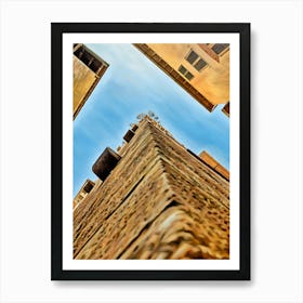 Lucca Guinigi Tower and Its Rooftop Trees. The Guinigi Tower, a historic landmark in Lucca, Italy, stands out for its unique rooftop garden featuring tall oak trees. Built in the 14th century, the red-brick structure embodies medieval architecture and offers panoramic views of the city for visitors who climb to the top. 1 Art Print