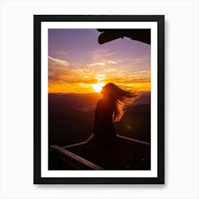 Woman Basking In Sunsets Glow On A Mountain Porch Silhouette Against A Sky Painted With Hues Of Or (3) Art Print