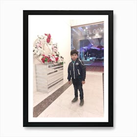 Boy Standing In Front Of Flowers Art Print