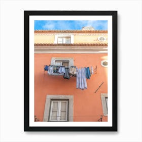 Laundry on a line in Alfama, Lisbon, Portugal with an orange stucco wall. Summer nature and travel photography by Christa Stroo Art Print