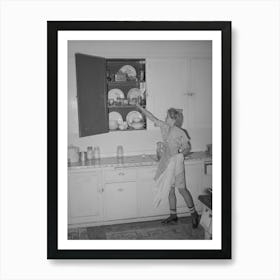 Daughter Of Morman I E Mormon Farmer Putting Away Dishes In Kitchen Cabinet Box Elder County, Utah By Art Print