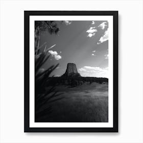 Devils Tower also known as Bears Lodge in Wyoming seen from a meadow and framed by trees Art Print