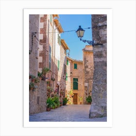 Romantic street in the old village of Valldemossa on Mallorca, Spain Balearic islands. Lose yourself in the idyllic old village of Valldemossa on Mallorca, Spain Balearic islands. This romantic street is a famous landmark that depicts the rich history and Mediterranean culture of the town. Art Print