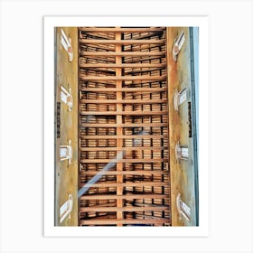 Architectural Ceiling Design. This image showcases an intricately designed ceiling, featuring a series of wooden beams arranged in a grid pattern. The beams create a sense of depth and structure, with light filtering through the gaps, casting shadows that enhance the three-dimensional effect. The sides of the ceiling are adorned with decorative elements resembling windows, adding to the architectural beauty and complexity of the design. Art Print