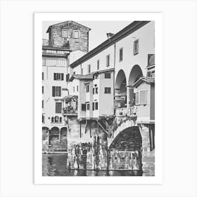 Ponte Vecchio Over the Arno River. A black-and-white depiction of Florence’s iconic Ponte Vecchio bridge, stretching over the Arno River. This historic bridge, adorned with small shops and classic Italian architecture, embodies the timeless beauty of Florence. 1 Art Print