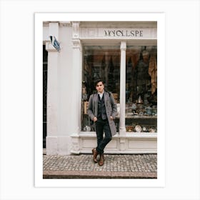 Youthful Spanish Man Adorned In Vintage Attire Standing In Front Of A Quaint Retro Shop Window Bo Art Print