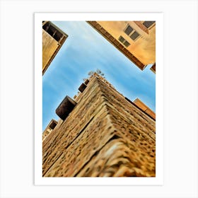 Lucca Guinigi Tower and Its Rooftop Trees. The Guinigi Tower, a historic landmark in Lucca, Italy, stands out for its unique rooftop garden featuring tall oak trees. Built in the 14th century, the red-brick structure embodies medieval architecture and offers panoramic views of the city for visitors who climb to the top. 1 Art Print