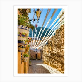 Spain, Valldemossa fiestas, lose yourself in the narrow, rustic streets of Valldemossa, a charming old village in Mallorca, Spain. Admire the Mediterranean stone buildings adorned with potted plants and flowers, showcasing the rich Balearic Island culture and history. Art Print