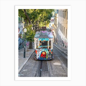 A streetcar sprayed with graffiti in Bairo Alto in Lisbon - summer street and travel photography by Christa Stroo Art Print