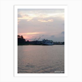 Sunset view of a river while a commercial boat passing through it Art Print