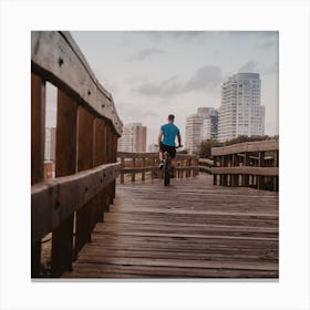 Man Riding Bike On Wooden Boardwalk Canvas Print